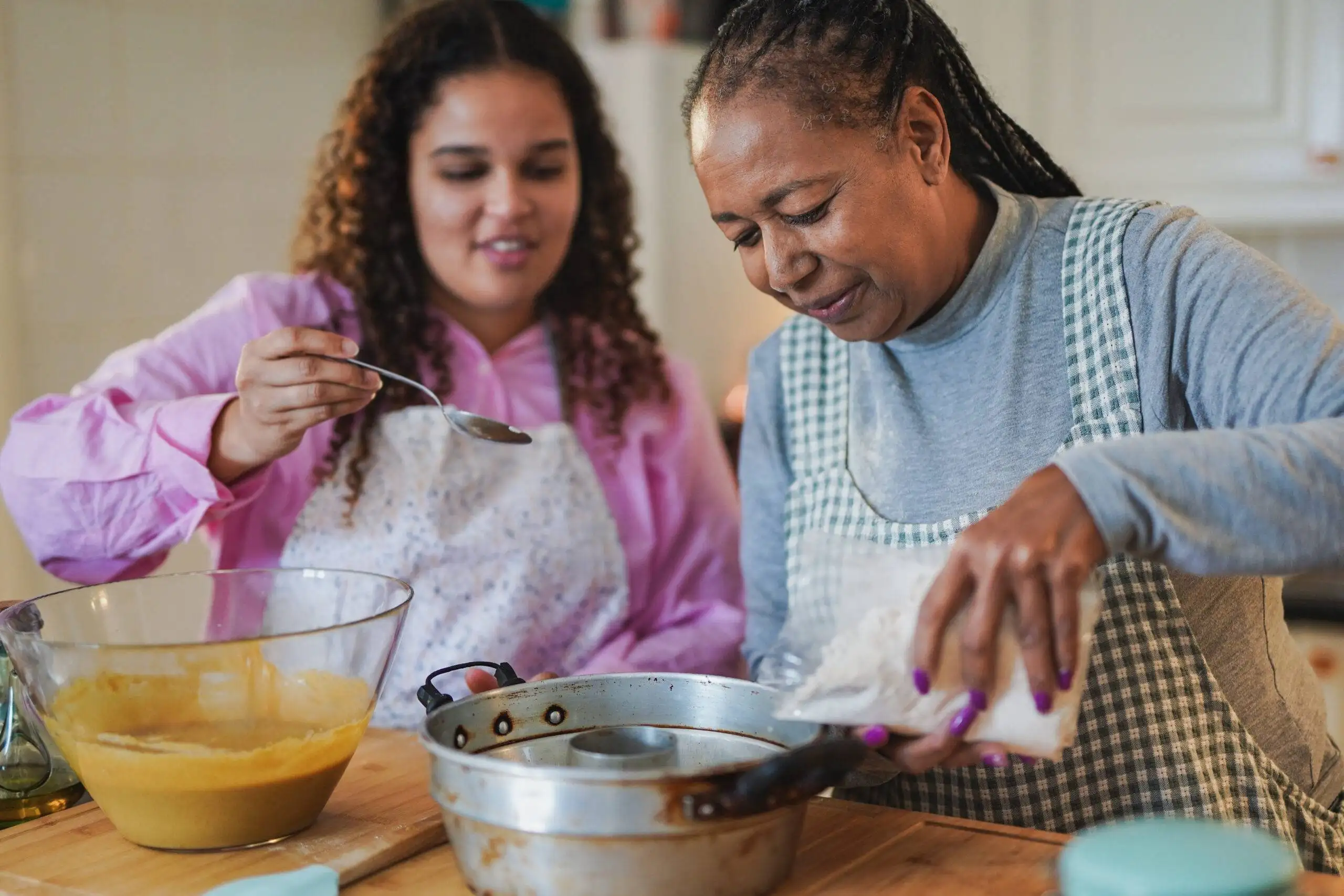 Mother and daughter having fun baking cake - Sugarspoon Desserts - Sugarspoon Desserts