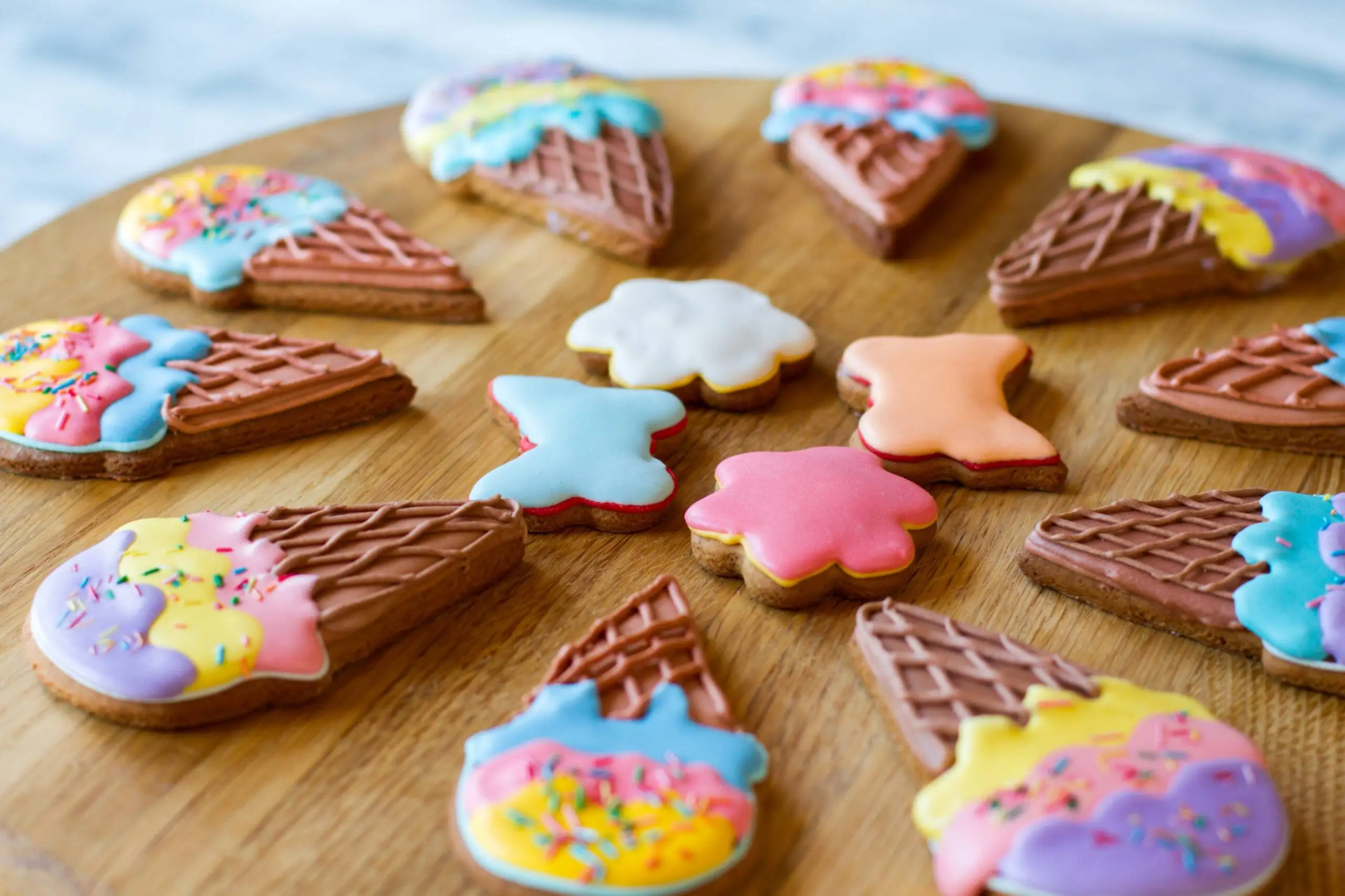 Colorful cookies on wooden board - Sugarspoon Desserts