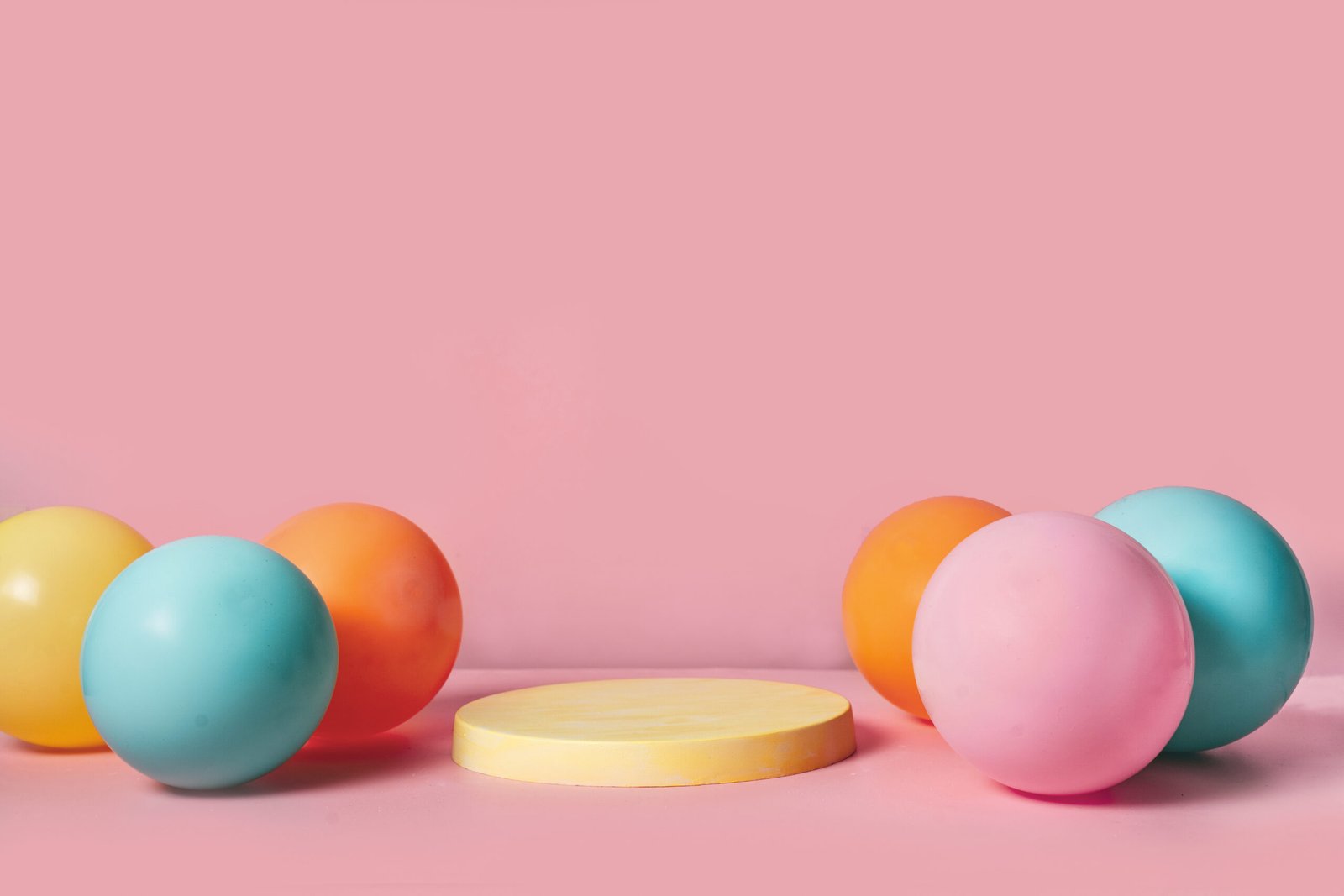 Product podium stage with pastel color balloons - Sugarspoon Desserts