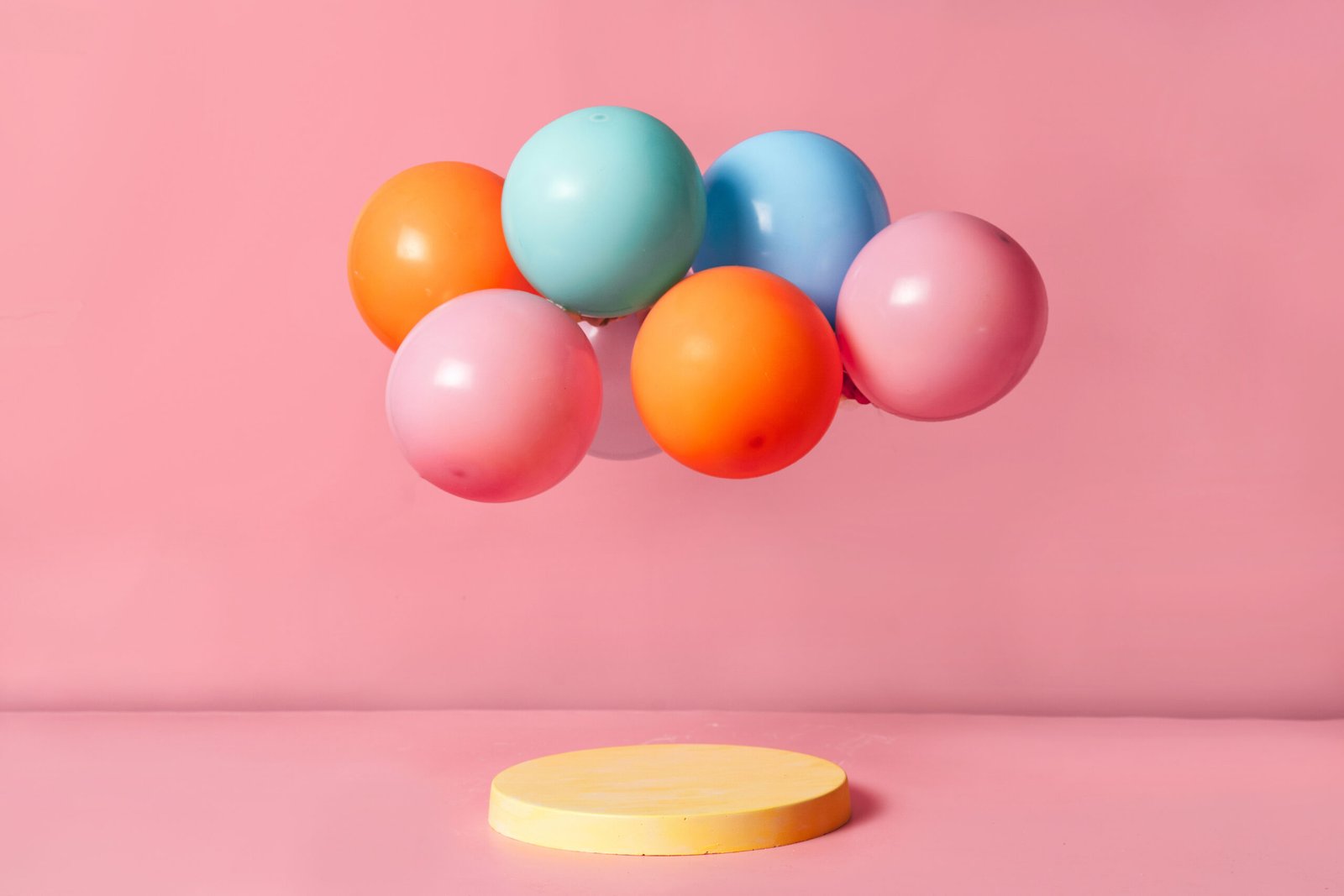 Product podium stage with pastel color balloons - Sugarspoon Desserts